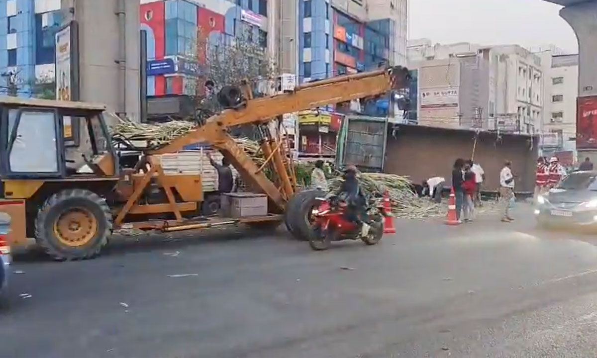 Sugarcane-loaded truck overturns at Kukatpally