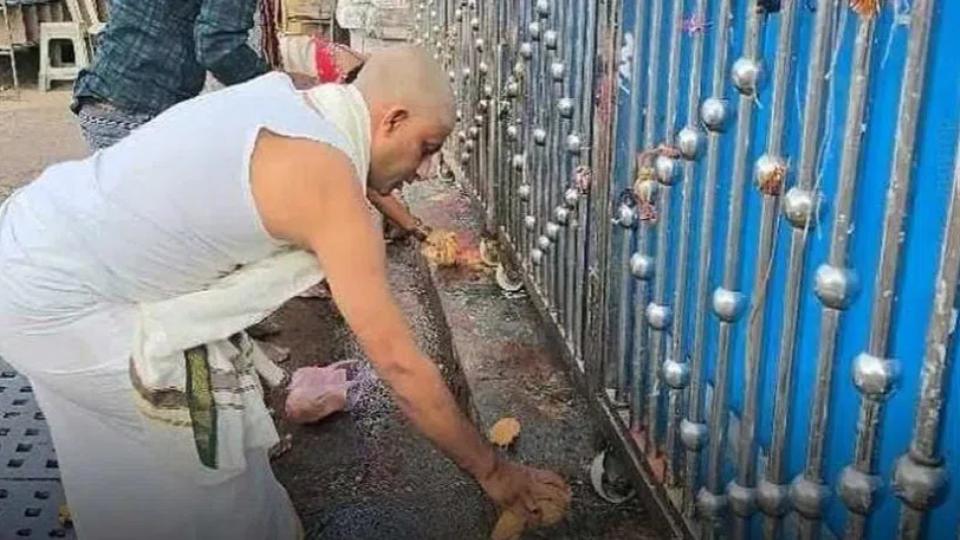 Devotees perform pujas before closed gates of temple in Karimnagar
