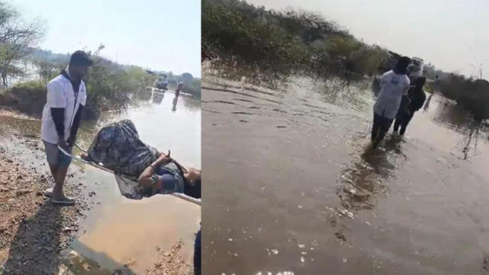 Ambulance staff carry pregnant woman across submerged road in Sangareddy