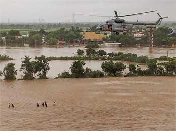 Priest’s family rescued from flooded temple rooftop 
