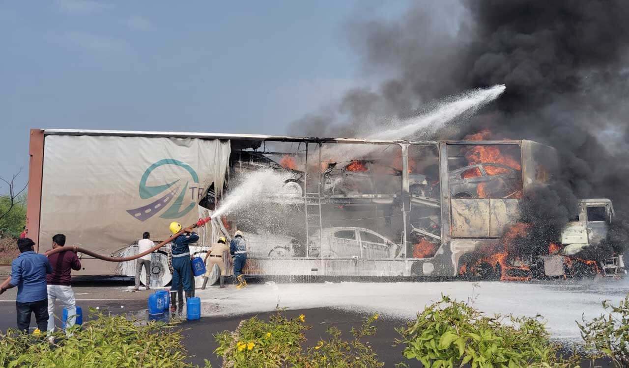 containerlorrywithcarscatchesfireonnh65atzaheerabad