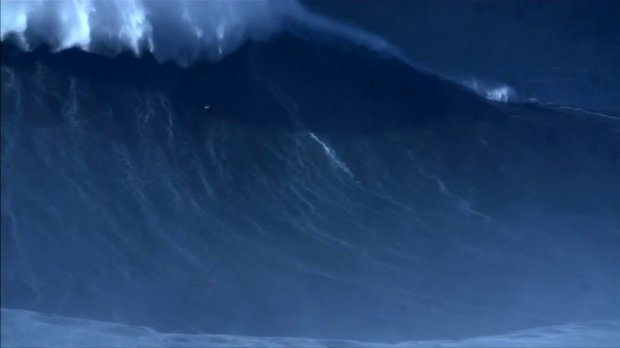 surferbreaksrecordforbiggestwaveeverriding80ftwallofwater