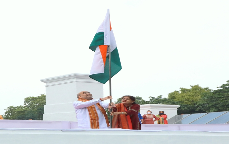 HM Amit Shah hoists National Flag at his residence in New Delhi